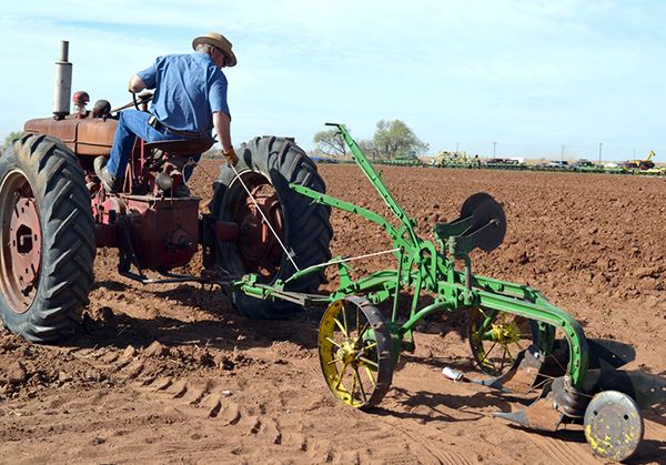 A man drives a tractor in a field